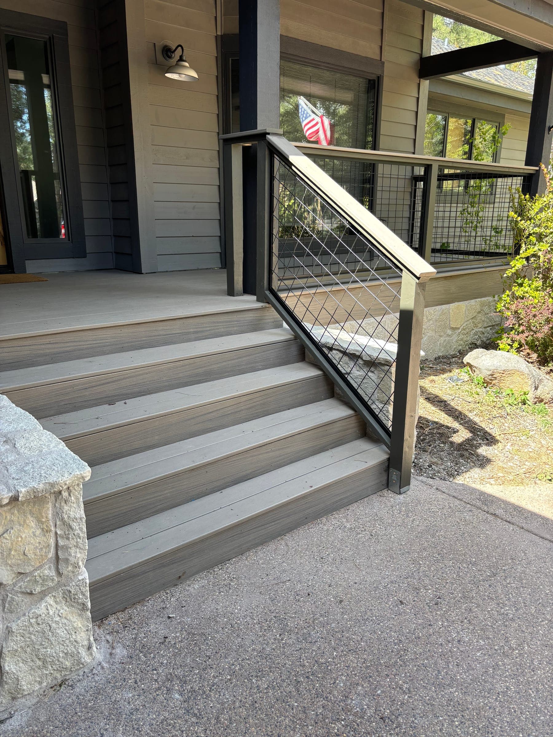 Custom deck with wire mesh railing and stone columns