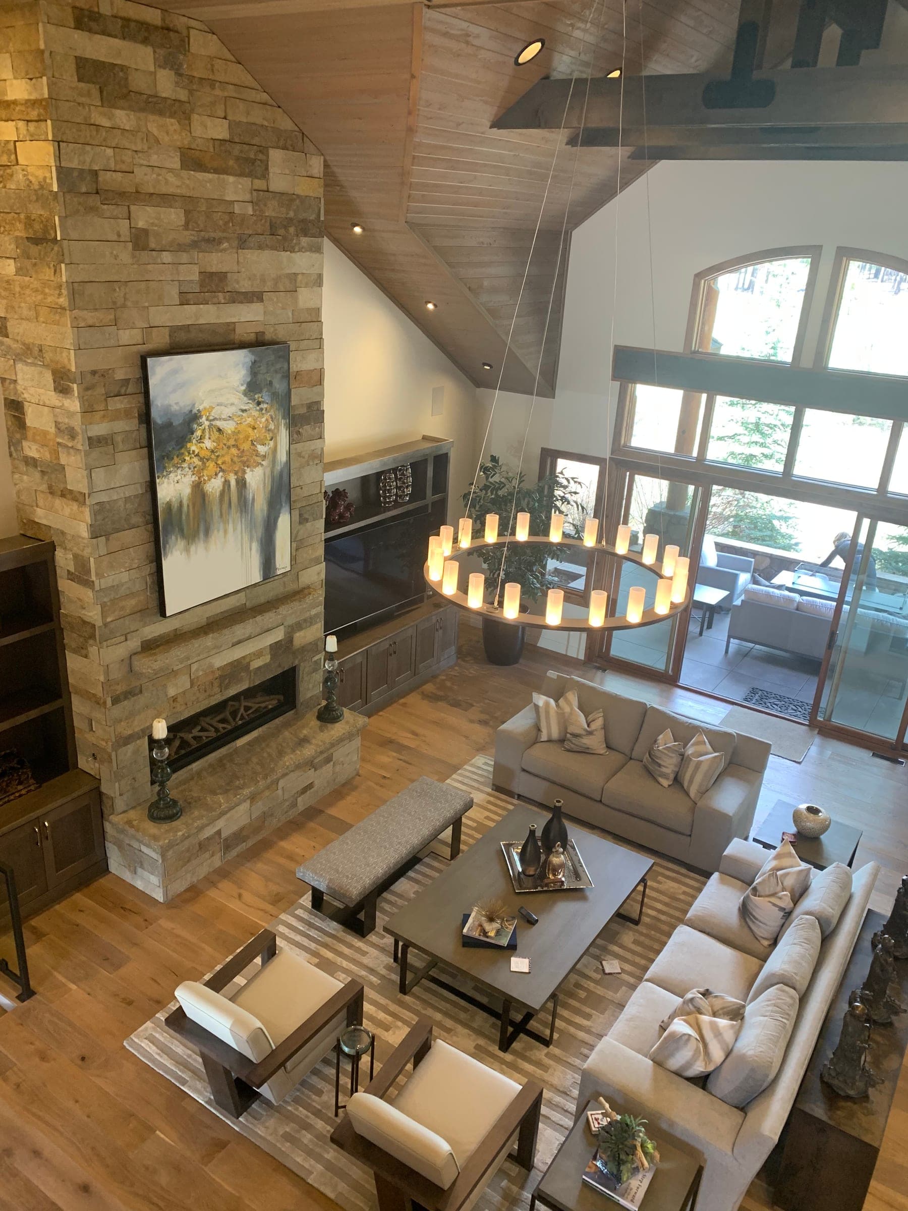 Wider view of the great room from the loft, showing the sliding glass doors to a covered patio